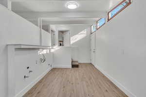 Foyer entrance featuring baseboards and light wood-style flooring