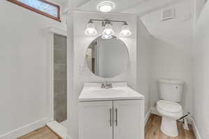Half bath featuring vanity and light wood-style flooring