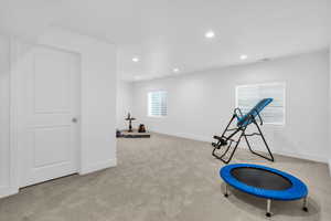 Workout area with light colored carpet and recessed lighting