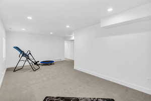 Exercise area featuring recessed lighting and light colored carpet