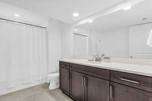 Bathroom featuring recessed lighting, vanity, light tile patterned floors, and shower / bath combination with curtain