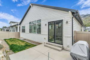 Back of property featuring a patio area, entry steps, and board and batten siding