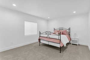 Bedroom featuring recessed lighting and light carpet