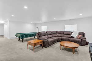 Living area featuring recessed lighting, healthy amount of natural light, light carpet, and billiards