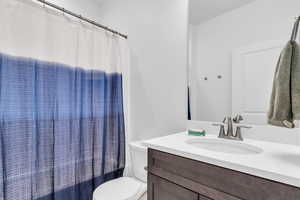 Full bath featuring vanity and shower / bath combination with curtain