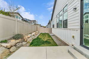 Fenced backyard with a patio and a residential view