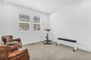Exercise room with carpet floors and recessed lighting