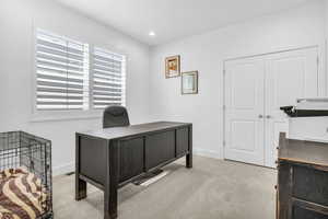 Office with carpet and recessed lighting