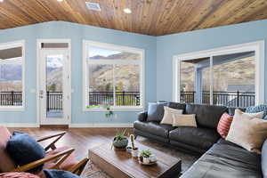 Living room with a vaulted wood ceiling, wood finished floors, and a mountain view