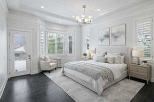 Bedroom featuring access to exterior, suspended lighting, and wooden ceiling
