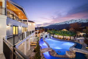 Pool at dusk featuring a patio, a mountain view, and a fenced backyard