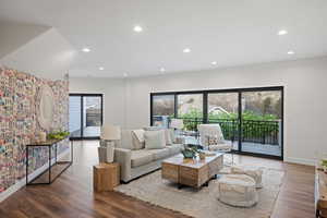 Living area with wood finished floors and recessed lighting