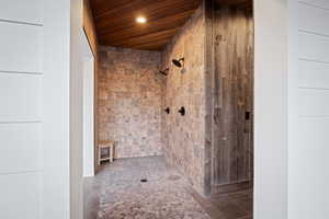 Full bathroom with wooden ceiling and tiled shower