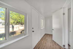 Entrance foyer with light wood-type flooring and baseboards