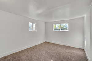 Unfurnished room featuring carpet flooring and a textured ceiling