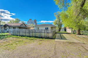 Rear view of house featuring a storage unit