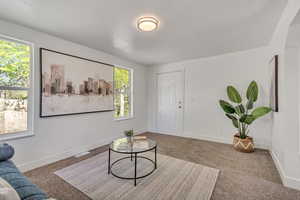 Sitting room with baseboards and carpet