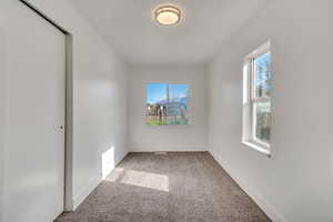 Empty room with light carpet and a mountain view