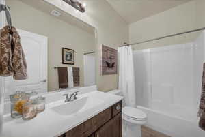 Full bathroom featuring vanity, shower / tub combo with curtain, and light tile patterned floors