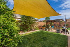 Fenced backyard featuring a pergola and a patio area