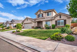 Traditional home featuring stucco siding, driveway, and a front lawn