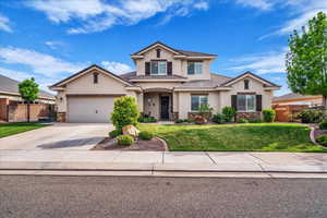 Traditional home featuring stone siding, stucco siding, concrete driveway, a garage, and a tiled roof