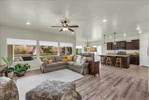 Living area featuring a ceiling fan, light wood finished floors, and recessed lighting