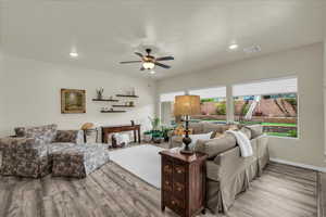 Living room featuring ceiling fan, light wood finished floors, and recessed lighting