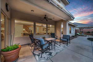 Patio terrace at dusk featuring a patio and a ceiling fan