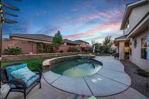 Combined pool / hot tub featuring a patio and a fenced backyard