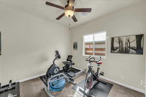 Exercise room featuring ceiling fan and light colored carpet