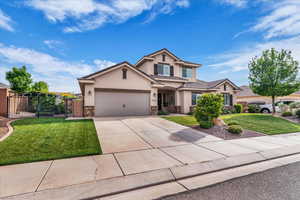 Traditional-style home featuring stone siding, stucco siding, driveway, and an attached garage