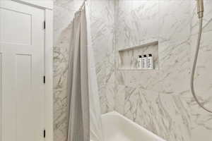 Bathroom featuring shower / bath combo with shower curtain