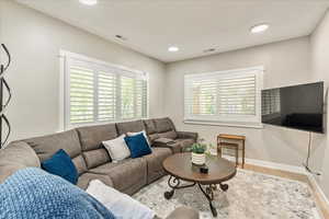 Living room featuring wood finished floors and recessed lighting