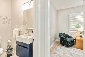 Bathroom with vanity and light wood-style floors