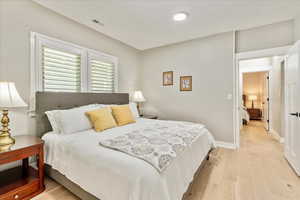 Bedroom featuring light wood-style flooring and baseboards