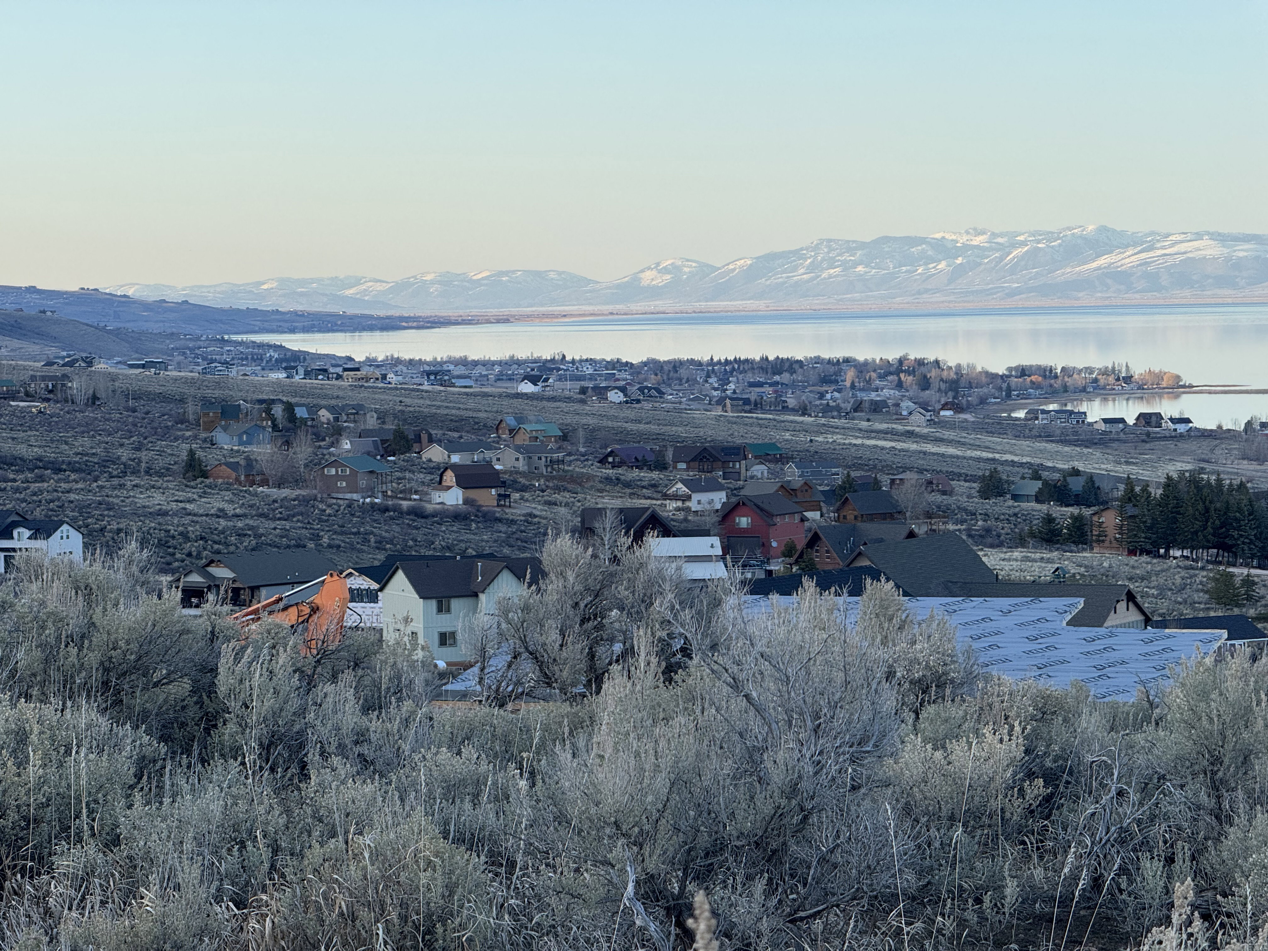 Aerial perspective of suburban area featuring a water and mountain view