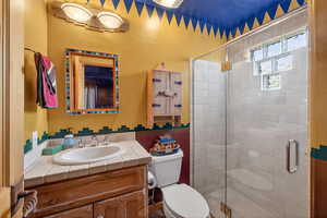 Full bathroom with vanity and a shower stall