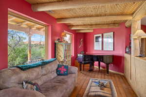 Living area featuring hardwood / wood-style flooring and beam ceiling