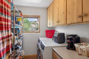 Laundry area with cabinet space and independent washer and dryer