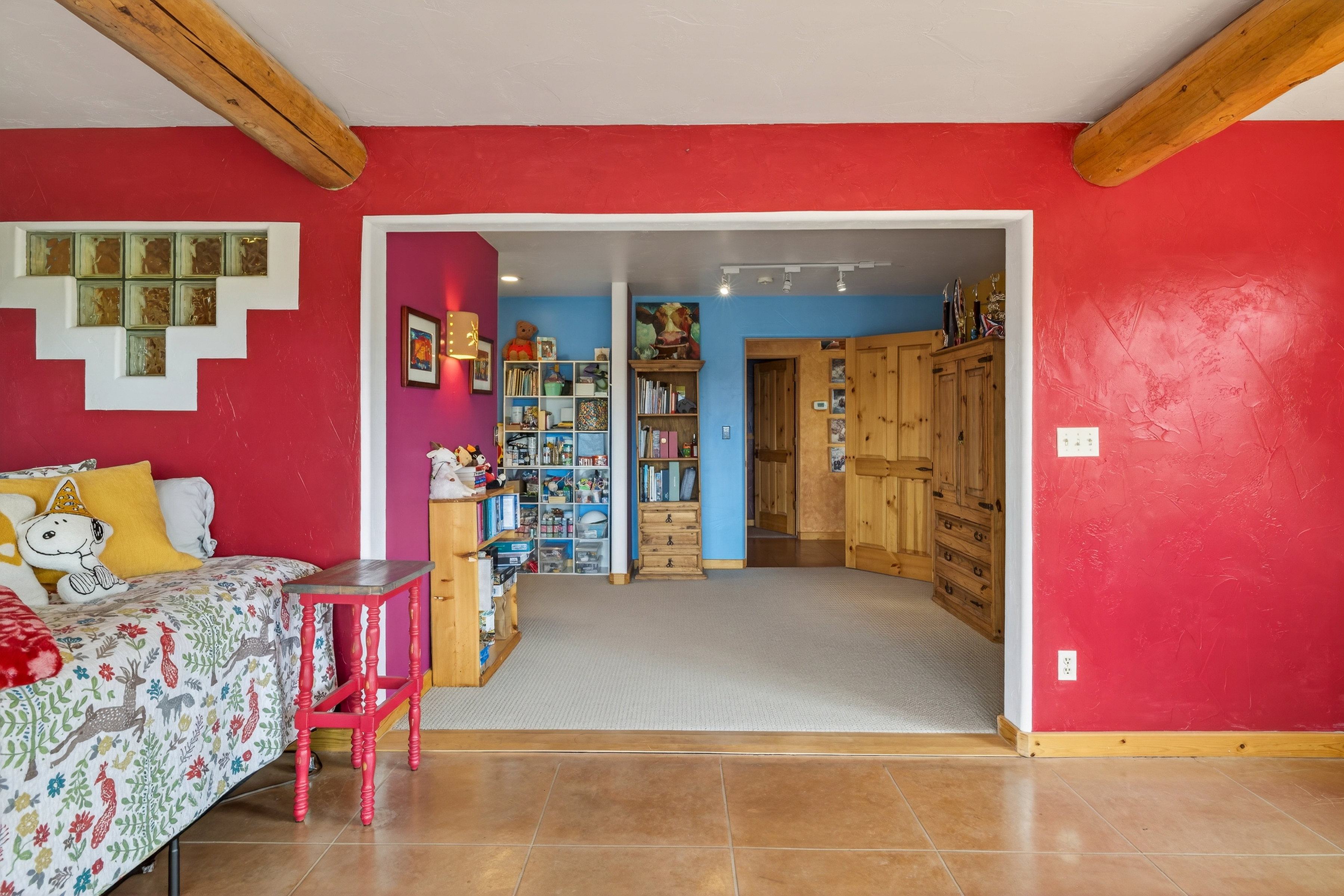 Bedroom with beam ceiling and tile patterned flooring