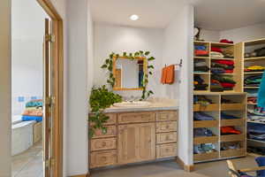 Bathroom featuring vanity, recessed lighting, and light colored carpet
