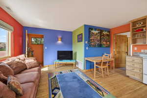 Living room with light wood finished floors and baseboards