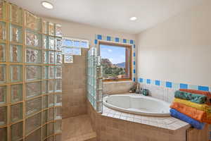 Full bathroom featuring a walk in shower, a bath, a mountain view, and recessed lighting