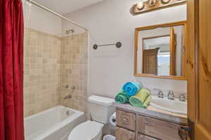 Full bath featuring vanity and shower / bath combo with shower curtain