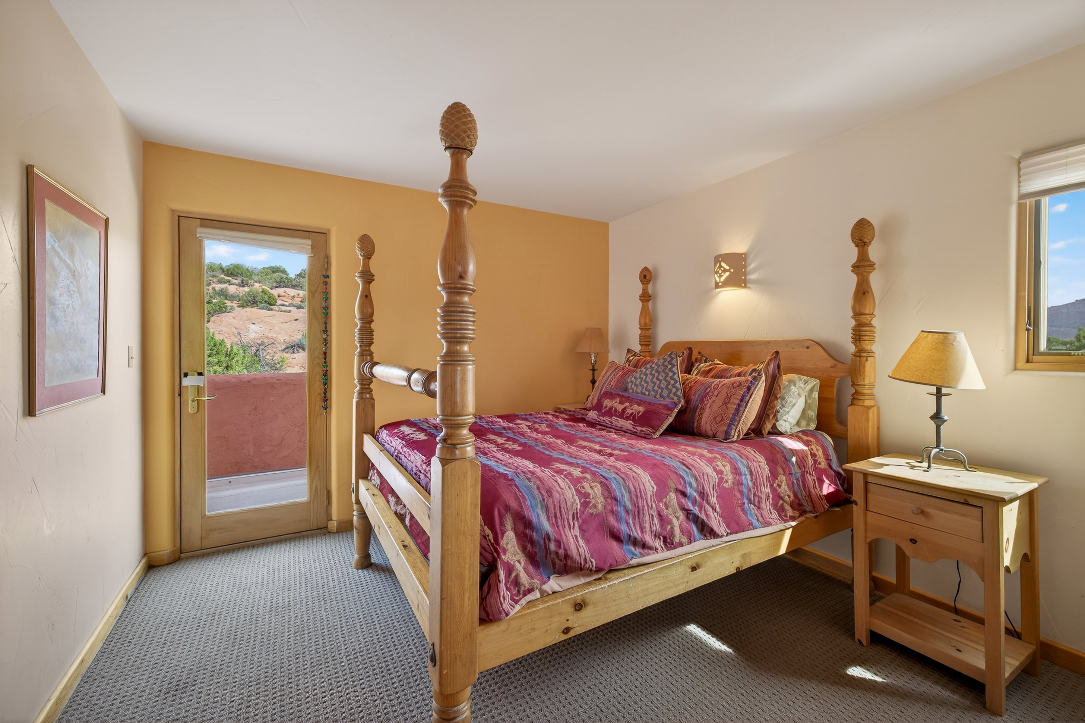 Bedroom with access to outside and carpet floors