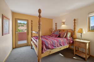 Bedroom with access to outside and carpet floors