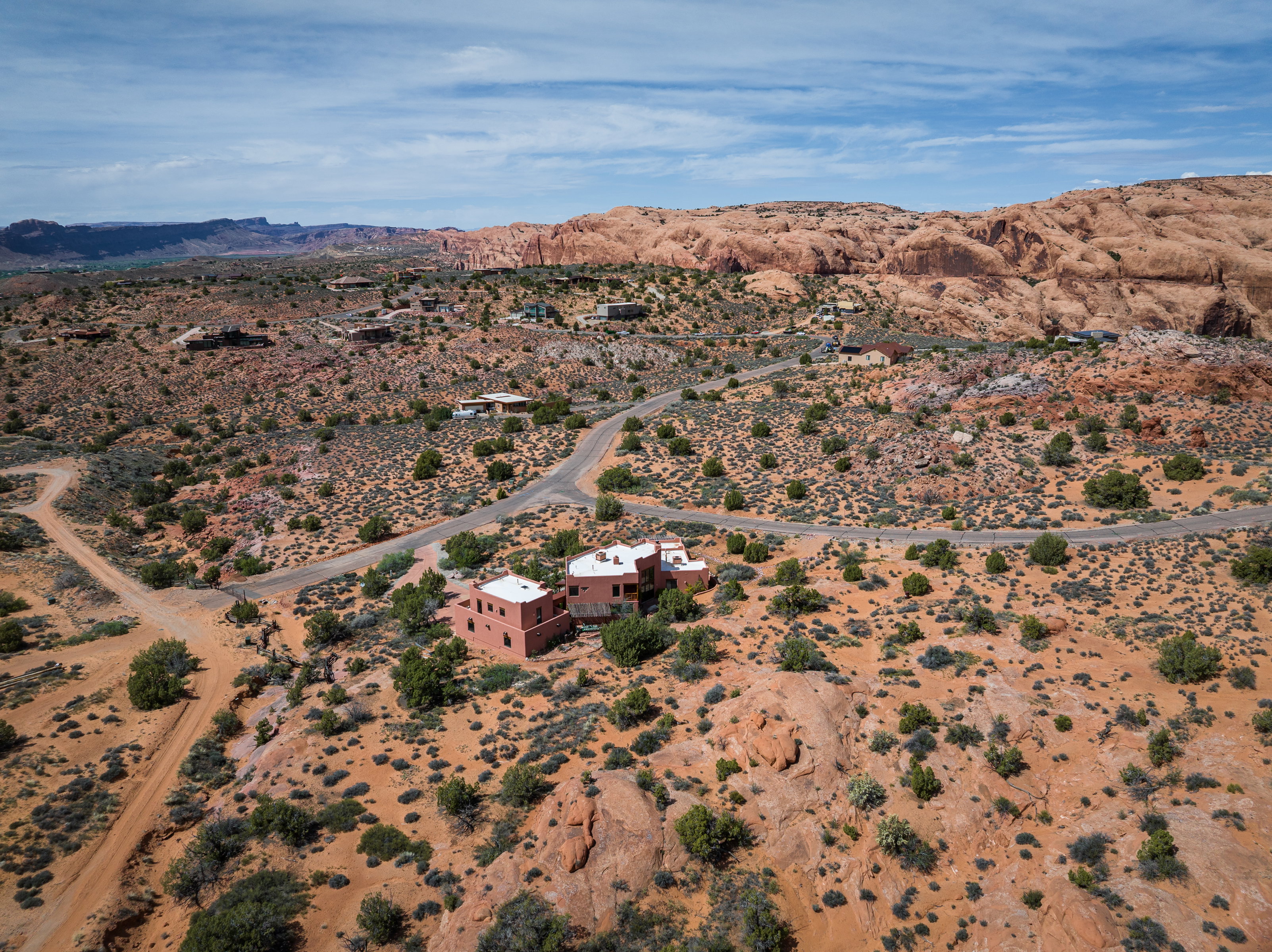 Aerial view of sparsely populated area featuring a desert landscape and a mountain backdrop