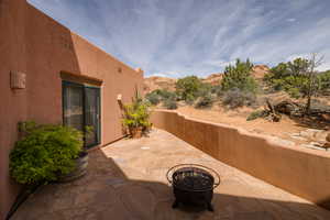 View of patio with an outdoor fire pit and a mountain view