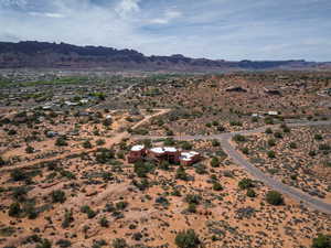 Overview of rural landscape featuring a desert landscape and a mountainous background